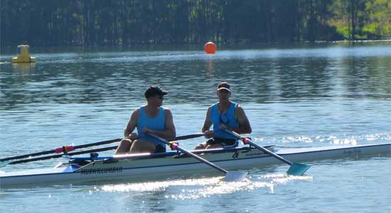 2 Men Rowing on Lake